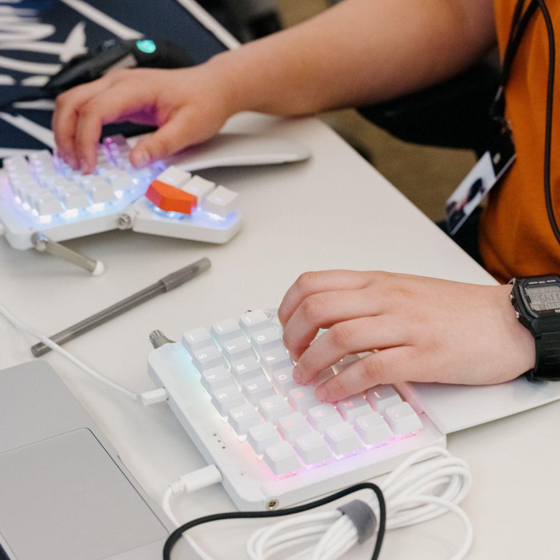 Close-up of hands on a split keyboard